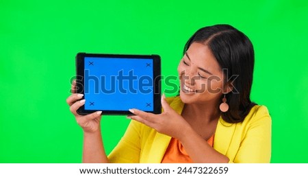 Tablet, advertising or branding and a woman on green screen background in studio holding a display with tracking markers. Portrait, marketing website and a happy young asian female holding chromakey