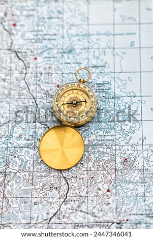 Map and compass. The magnetic compass is located on a paper navigation map.