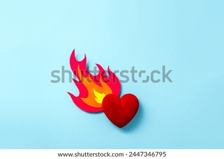 Flame cut out of cardboard and decorative velvet heart. Valentine's Day banner. Selective focus, copy space