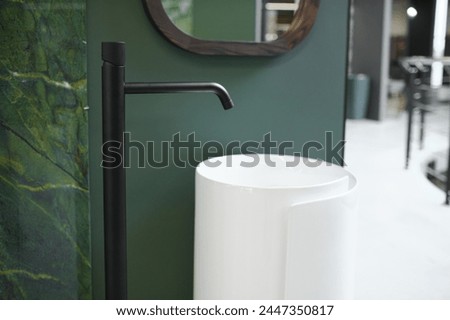 Interior photography of plumbing establishment where tiles, bathtubs, furniture and toilets are sold.