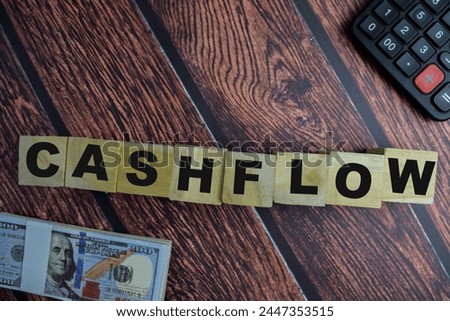 Concept of The wooden Cubes with the word Cashflow on wooden background.