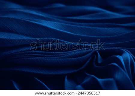Dark blue silk fabric. Aesthetic tissue texture, folded dress textile background. Ocean aqua dunes, luxurious chiffon clothing, indigo 3d sea waves, abstract deep water