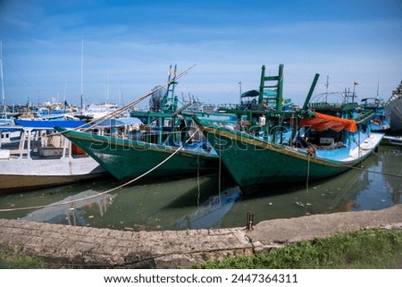 Traditional wooden boats anchor at Paotere Traditional Harbor in Makassar.  Royalty-Free Stock Photo #2447364311