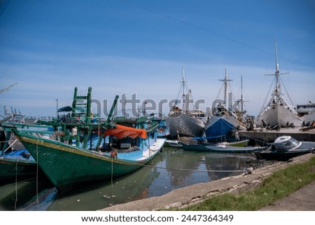 Traditional wooden boats anchor at Paotere Traditional Harbor in Makassar.  Royalty-Free Stock Photo #2447364349