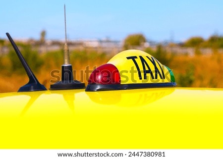 Taxi sign atop the car. Yellow cab top 
