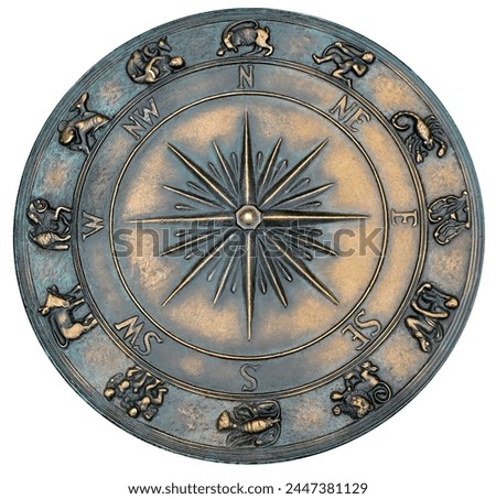 fragment decorative compass points with north, south, east, and west on the cement ground with horoscope elements of zodiac signs isolated on white with clipping path