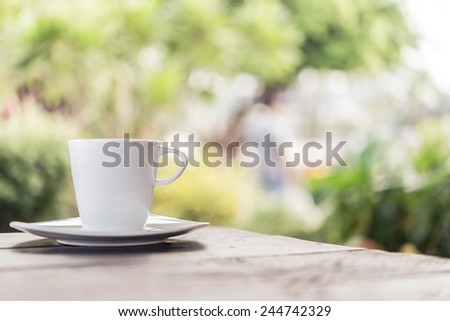 White coffee cup on wooden tables and outdoor garden background - Processing color effect style pictures