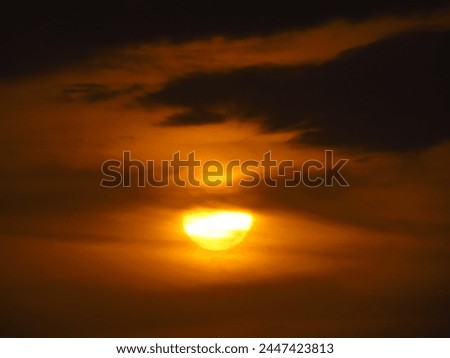 dusky view of the setting sun during sunset in the evening Royalty-Free Stock Photo #2447423813