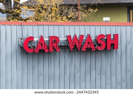 Red colored Car Wash sign on a metallic fence, great for commercial use