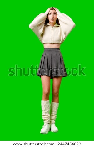 Young Woman Expressing Shock and Surprise Against a Green Screen Background