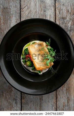 Grilled cod fillet with steamed vegetables. A healthy dietary fish dish, top view