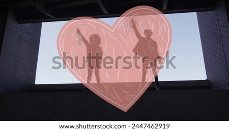 Image of read heart over two woman lifting fists. female power, feminism and gender equality concept digitally generated image.