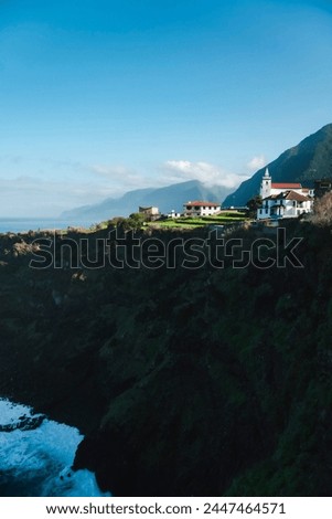 mountain with houses on the coast