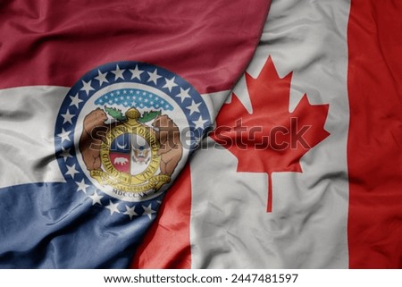 big waving realistic national colorful flag of missouri state and national flag of canada . macro