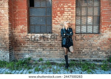 Young beautiful strong independent rebel blonde woman Punk music and style fan posing. Confident Punk-Rock youth culture street style concept. Cool attitude bee different concept