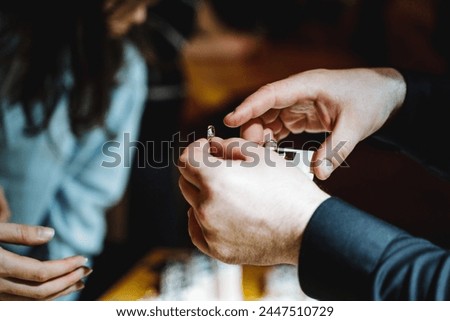 During the event, the man made a loving gesture by putting a ring on the womans finger. The ring slipped easily over her nail, resting on her flesh as a symbol of their shared commitment