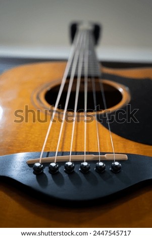 acoustic guitar strings fretboard sound hole and electronic part of guitar component Royalty-Free Stock Photo #2447545717