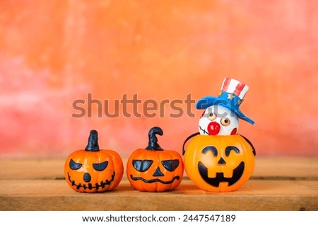 Halloween pumpkin and wooden Bozo ghost with space on orange cement wall, Happy halloween card background idea