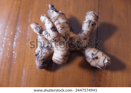 Galangal on a brown wooden background, cooking spices, herbs, stock photo.