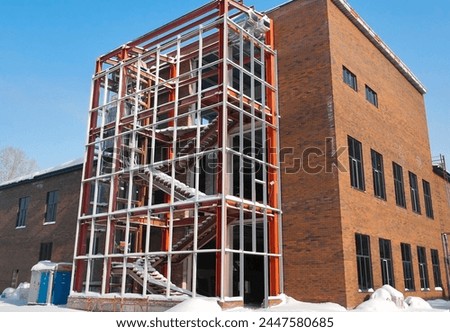 Metal frame of the building with a sandwich panel of insulation on the wall. Construction of a new commercial building. Ust-Kamenogorsk, (kazakhstan)