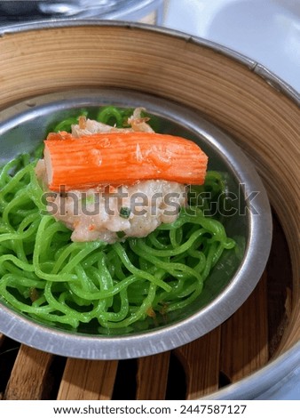 a photography of a bowl of noodles with carrots and meat.