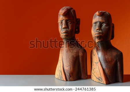 woodoo sculpture, orange background, isolated