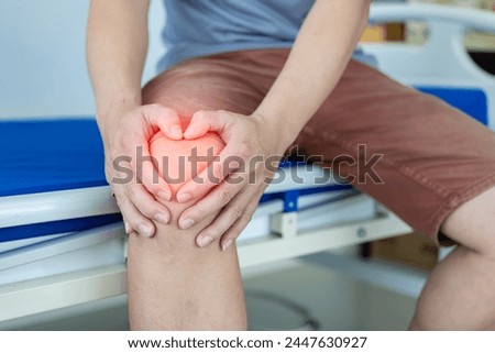 Osteoarthritis is common in the elderly, causing knee pain, swelling, redness, knee stiffness, and a loud noise in the knee, suffering from knee pain while sitting on the bed at home. Health concept Royalty-Free Stock Photo #2447630927