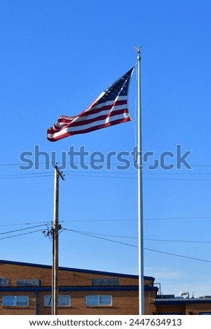 Blue sky over American flag on a flagpole