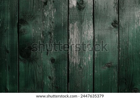 Wooden background made of old green boards, old boards, texture of carquelure