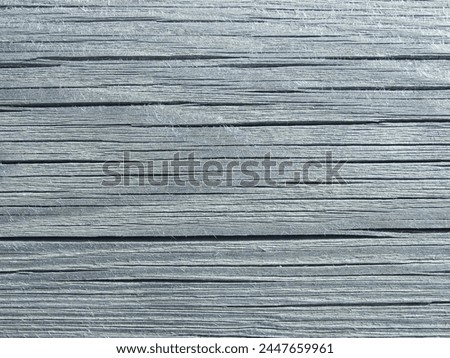Texture of an old weathered cracked wooden board. Natural Background. Texture of an old rough wooden board.