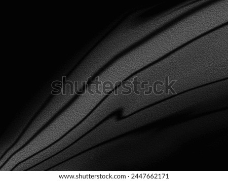 A Close-up shot of a grey surface. It features elements like black, abstract shapes, shadows, monochrome color scheme, black and white colors and light.