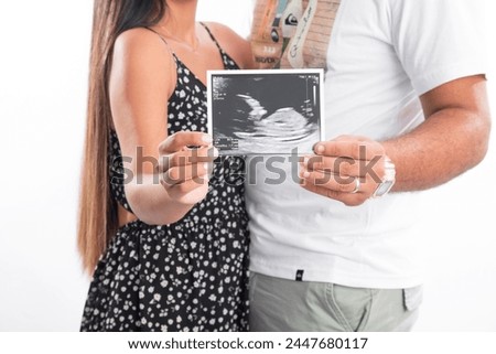 Big Pregnant belly with echography showing baby picture motherhood