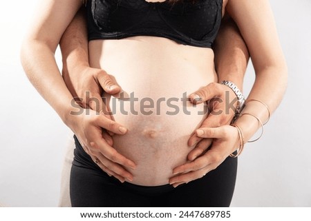 Family members hands touching holding their mother big pregnant belly family brotherhood sisterhood