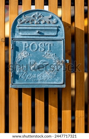 Old vintage blue metal mailbox or postbox on wooden background, Vintage post box, postal office, mailbox and mail delivery concept