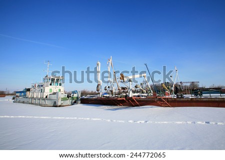 winter landscape old ship in the port laid up on a sunny day