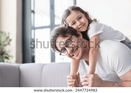 Loving cheerful young father with his small kid daughter girl having fun together, spending time, celebrating father`s day. I love you, dad! Parenthood, fatherhood concept Royalty-Free Stock Photo #2447724983