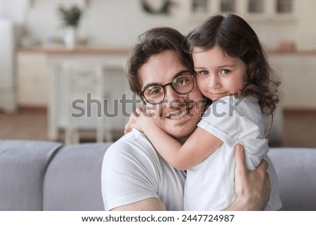 Young handsome father hugging his little small child daughter at home. Family time together. Parenthood and fatherhood, happy father`s day! I love you, dad! Royalty-Free Stock Photo #2447724987