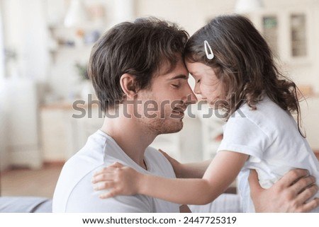 Loving cheerful family, young father and little daughter spending time together, hugging and embracing. Happy father`s day! I love you, dad! Parenthood and fatherhood concept
