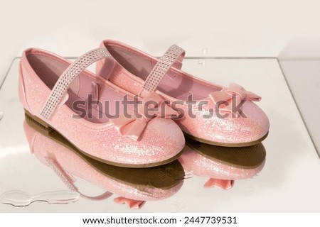 pair pretty pink dress shoes with bows and glitter for little princess on wet mirror with water drops background, happy childhood, Stylish pink outfit for special occasions