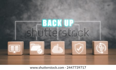 Backup concept, Wooden block on desk with backup icon on virtual screen.