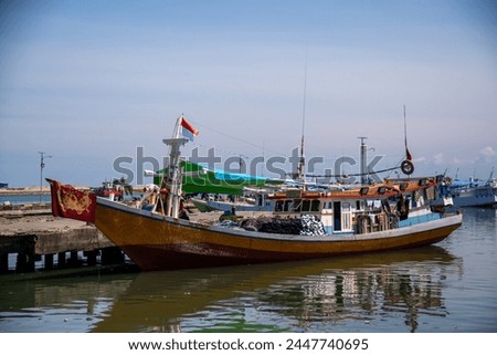 Brown wooden boats anchor at Paotere Traditional Harbour. Its located 4 km north of Makassar City. 