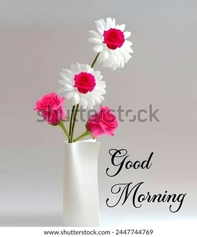 A Very Beautiful Pink and white flower in a white flower vase on a greyish and good morning written next to it