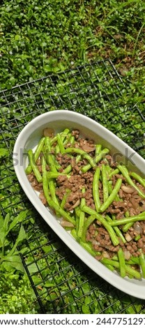 String green bean or french beans with minced beef stir fry or sauteed called Tumis buncis daging sapi cincang in Indonesia, selective focus