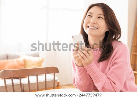 Young attractive Asian woman using a smart phone