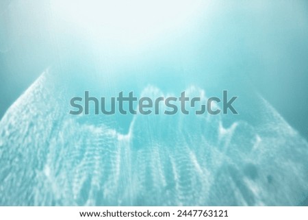 White shiny glare from sunlight on blue background, abstract nature seascape photo with sunshine flare, neutral color minimal aesthetic light effect, blurred natural backdrop, trend color gradient