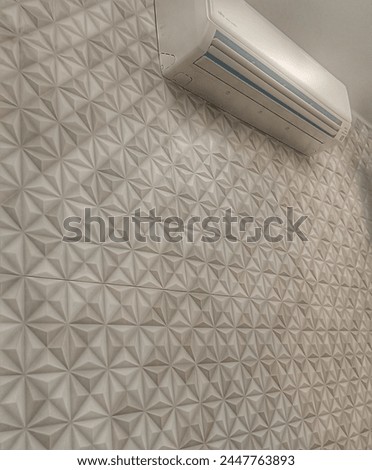 white geometric high relief 3D texture wall with shadow and white air conditioner above