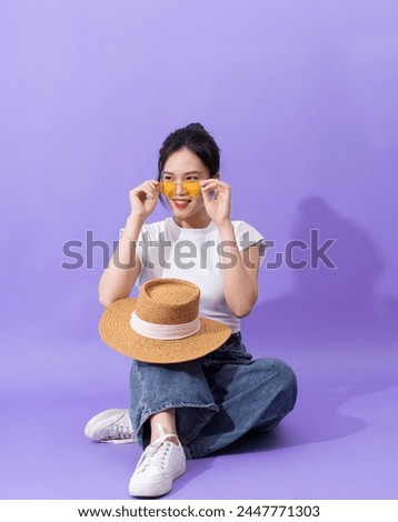 Young Asian teenager on purple background