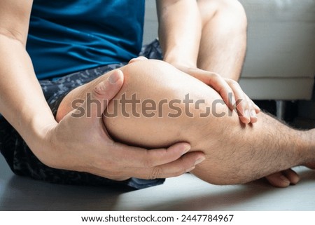 Man with knee pain, he puts his hand on his knee, pain point from osteoarthritis and osteoarthritis, medical concept and treatment Royalty-Free Stock Photo #2447784967