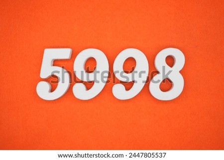 Orange felt is the background. The numbers 5998 are made from white painted wood.