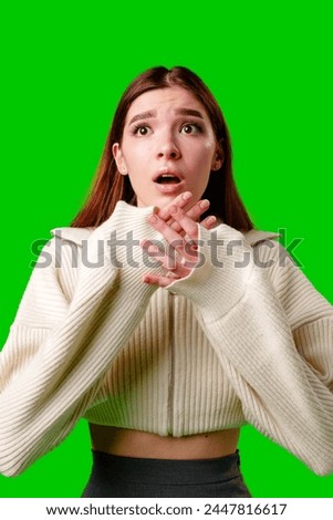 Young Woman Expressing Shock and Surprise Against a Green Screen Background
